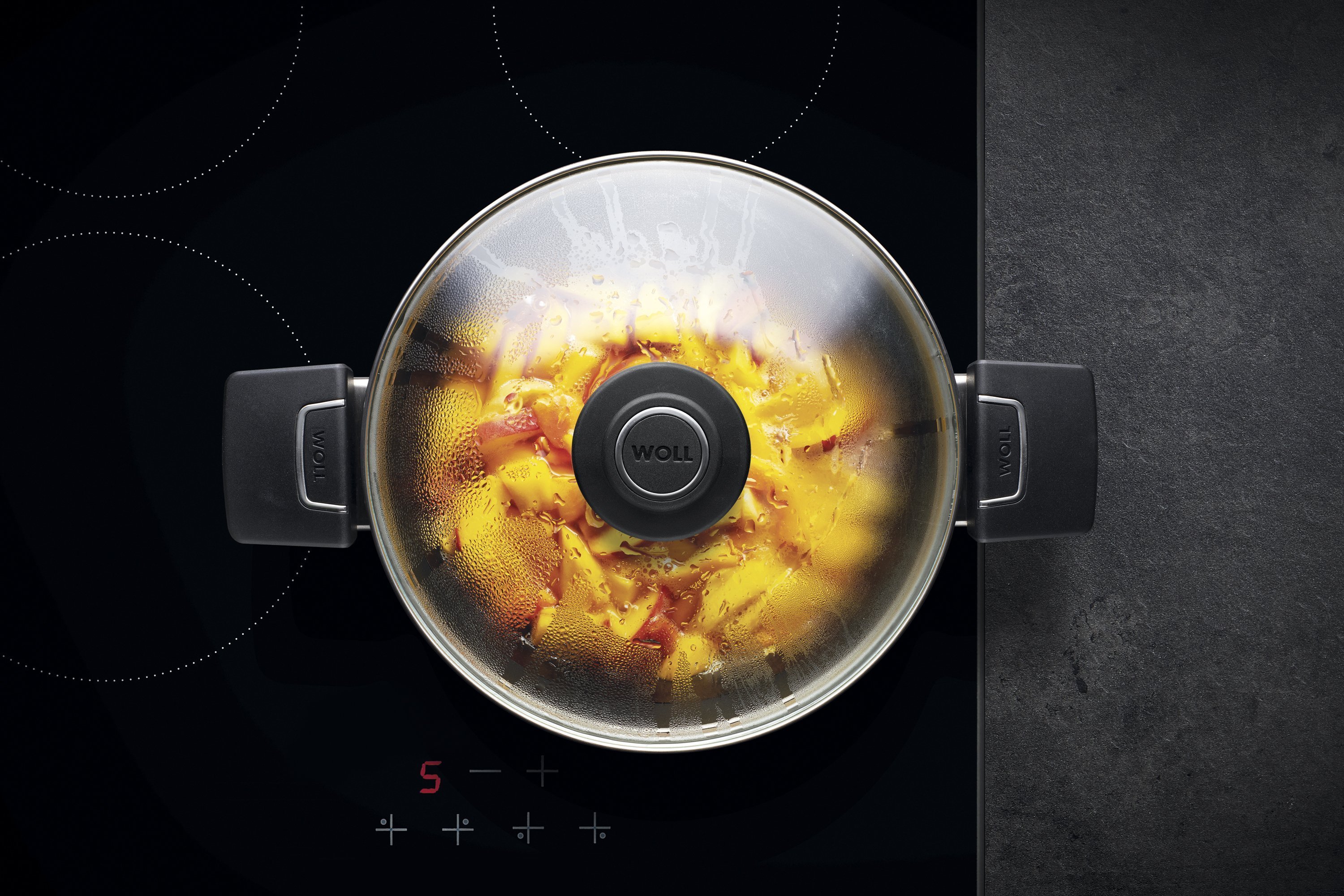 In einem runden Diamond LiteTopf wird ein Gericht zubereitet. Am Glasdeckel hat sich Kondenswasser gebildet.